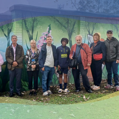 Involved people in front of mural wall